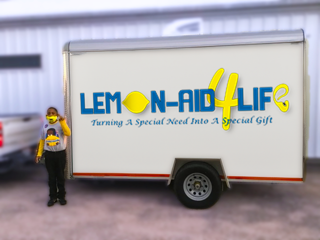 Leroy in front of trailer with Lemon-Aid4Life logo